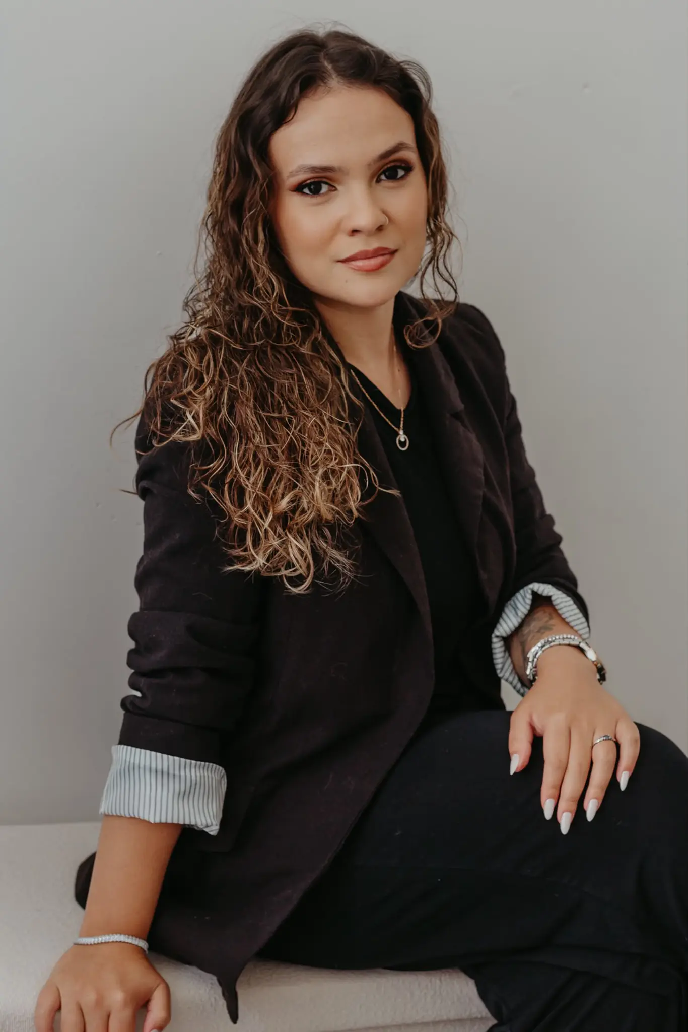 Luana Prudente no estúdio, junto ao seu certificado de formação